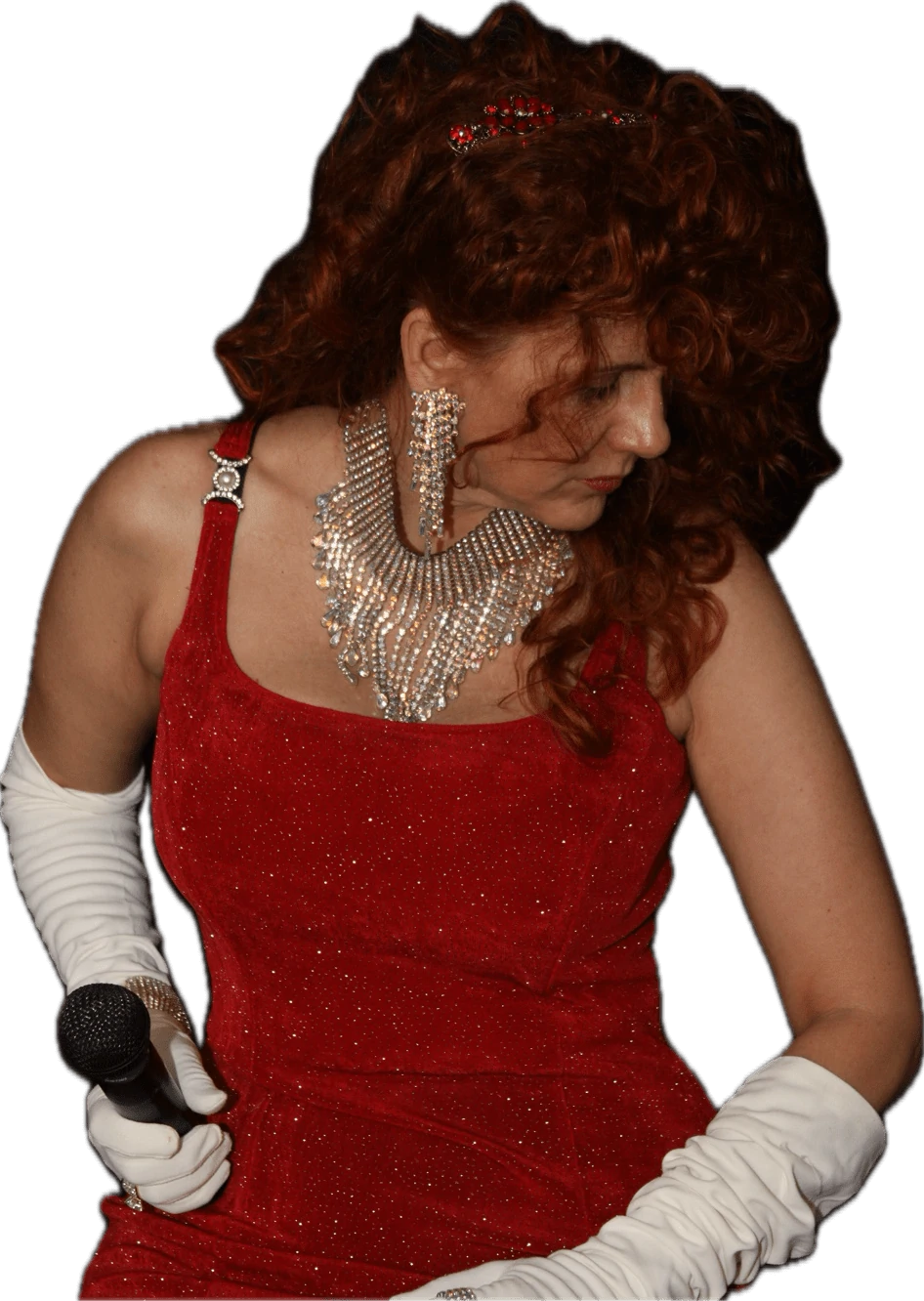 Keeli performing in a red dress and white gloves